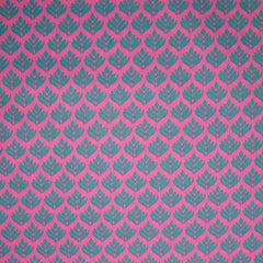 Popeline enduite imprimée végétale turquoise fond rose