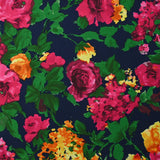 Viscose imprimée éclat de roses fuchsia et jaune fond marine